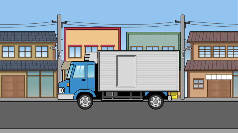 昭和の町並みを走るトラックのイラスト