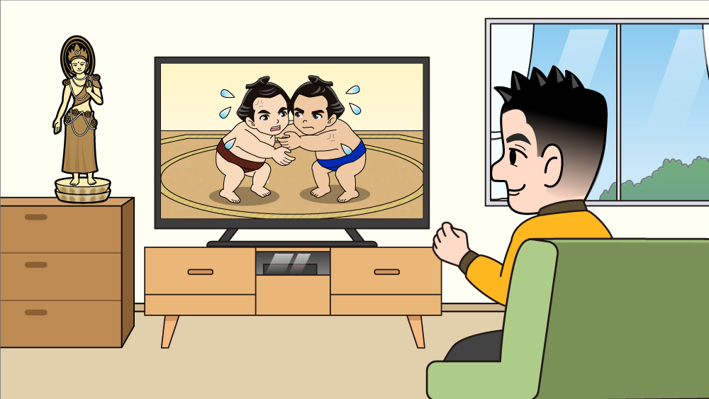 テレビで相撲観戦をする男性