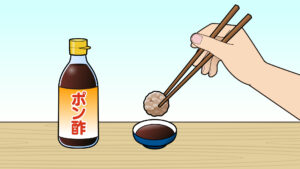 肉団子をポン酢につける様子